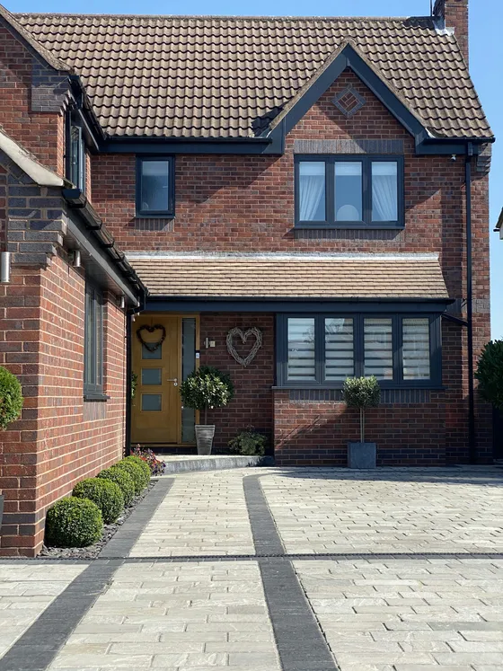 A red-brick house with a newly laid driveway