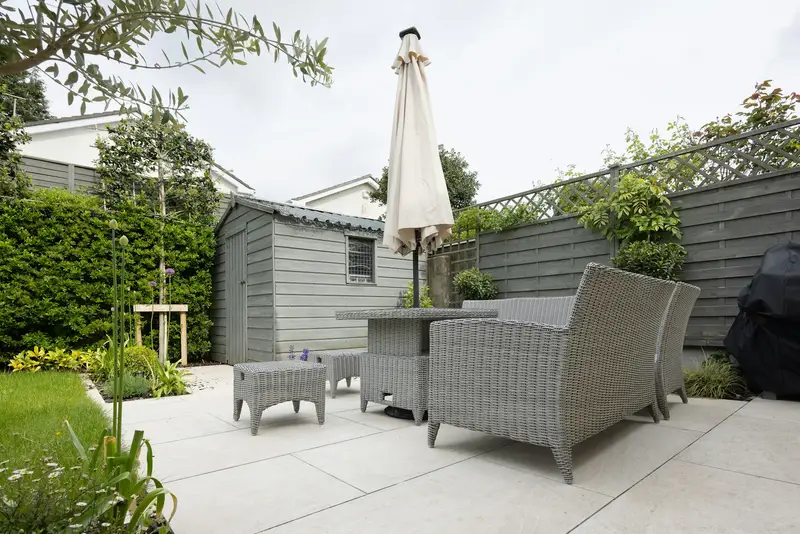 A finished garden patio with table and chairs