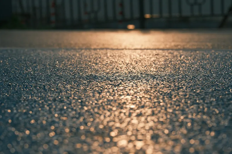 Close-up of a resin-bound driveway surface catching the light